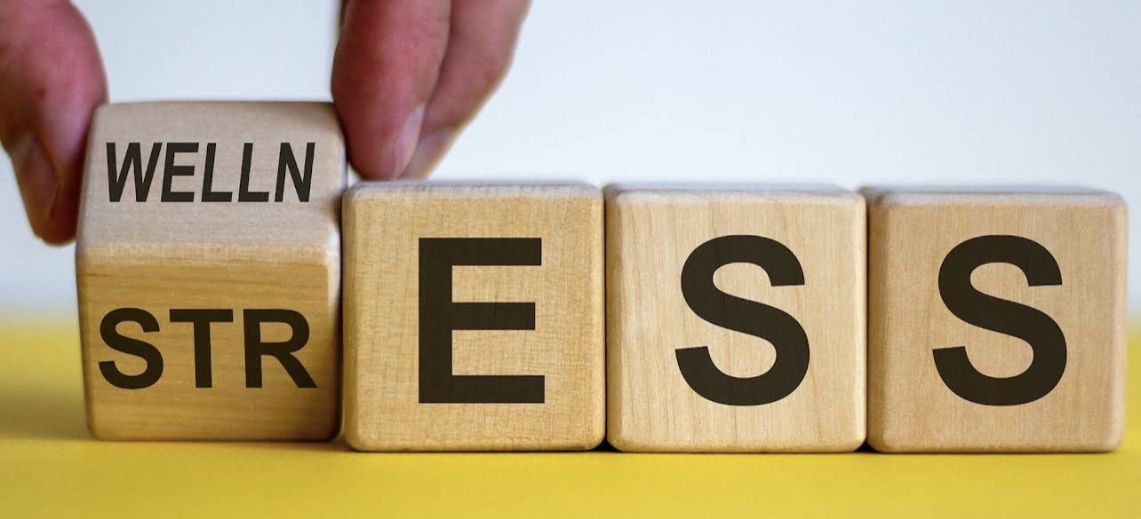 Wellness and stress concept blocks representing the benefits of fitness, stress management, and healthy living.